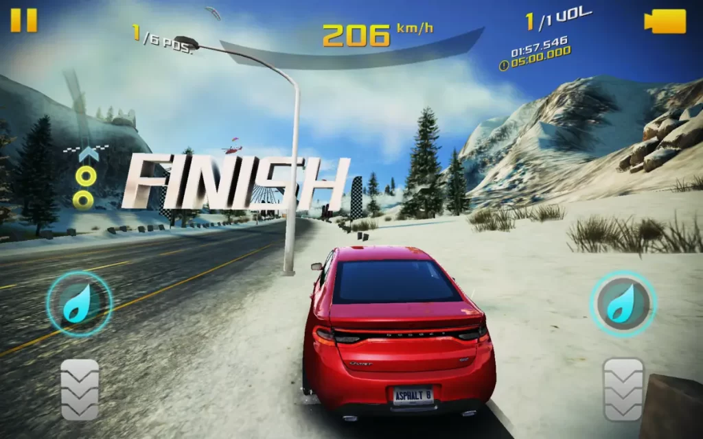 Image shows a car from the Asphalt 8 game racing on a snowy track with the word 'Finish' indicating the finish line.